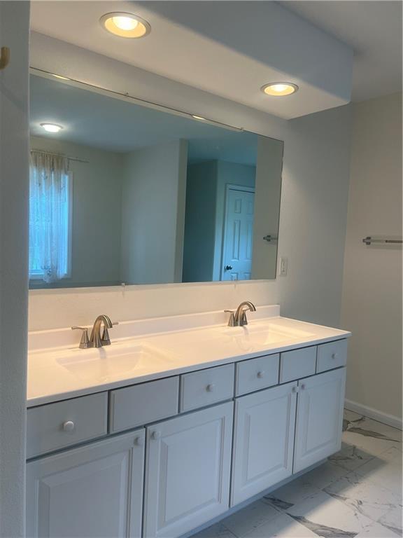 36987 W 63rd St, Camden, MO 64017 - bathroom with double vanity, marble finish floors, and recessed lighting