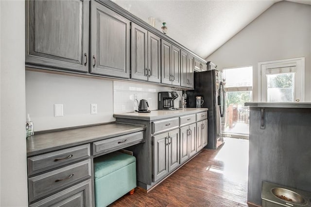 5323 Kenton St, Shawnee, KS 66226 - kitchen featuring gray cabinets, lofted ceiling, dark wood-style flooring, and black fridge
