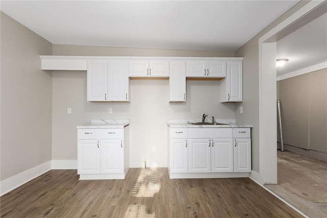 816 Chestnut St, Osawatomie, KS 66064 - kitchen featuring white cabinets, wood finished floors, and light countertops