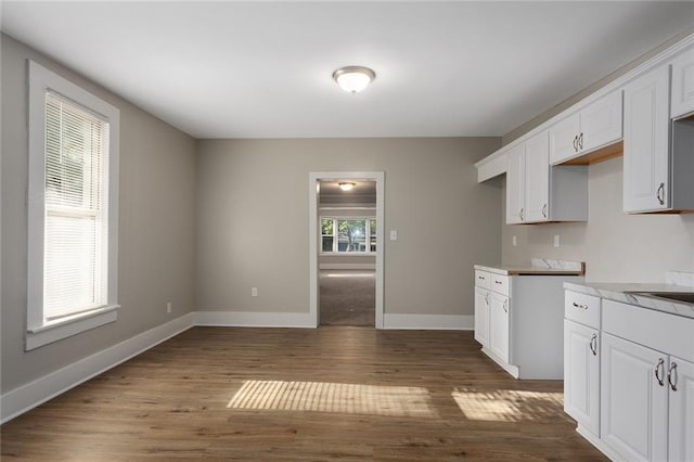 816 Chestnut St, Osawatomie, KS 66064 - kitchen with dark wood-style flooring, white cabinetry, and light countertops