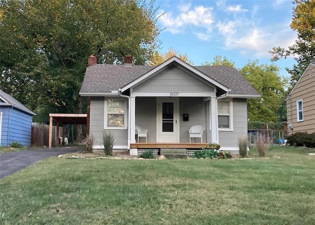 8007 Mercier St, Kansas City, MO 64114 - bungalow featuring a porch, a chimney, roof with shingles, and driveway