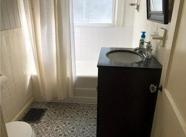 8007 Mercier St, Kansas City, MO 64114 - bathroom with vanity, shower / tub combo, and tile walls