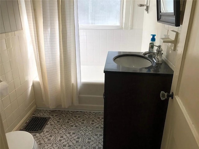 8007 Mercier St, Kansas City, MO 64114 - full bathroom with shower / bath combo, tile walls, and vanity