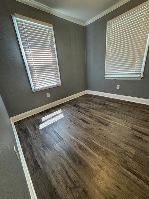 477 Shawnee Rd, Kansas City, KS 66103 - empty room with ornamental molding and dark wood-type flooring