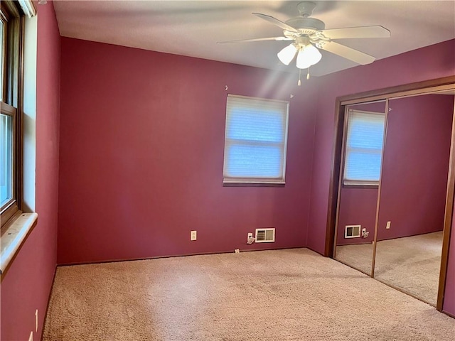 11510 Ridge Dr, Sugar Creek, MO 64054 - unfurnished bedroom featuring carpet, multiple windows, a closet, and ceiling fan