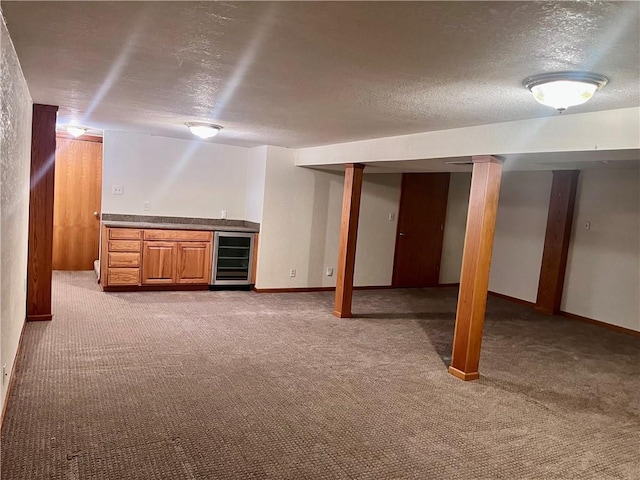 11510 Ridge Dr, Sugar Creek, MO 64054 - finished basement featuring wine cooler, bar area, a textured ceiling, and carpet floors