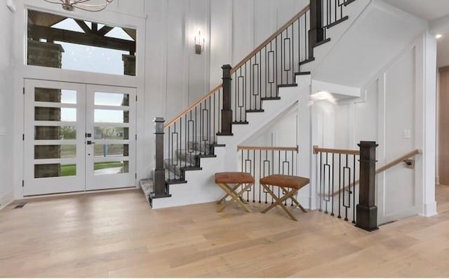 16377 W 166th Pl, Olathe, KS 66062 - foyer entrance with wood finished floors, french doors, a decorative wall, a towering ceiling, and stairway