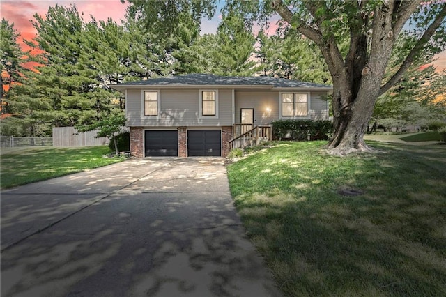 1413 SE 1st Ter, Lees Summit, MO 64063 - raised ranch with brick siding, driveway, and a garage