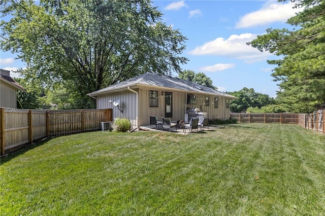 1413 SE 1st Ter, Lees Summit, MO 64063 - rear view of house featuring board and batten siding, a fenced backyard, a patio area, and an outdoor living space