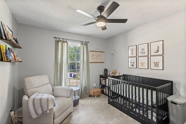 1413 SE 1st Ter, Lees Summit, MO 64063 - bedroom with carpet, a nursery area, a ceiling fan, and a textured ceiling