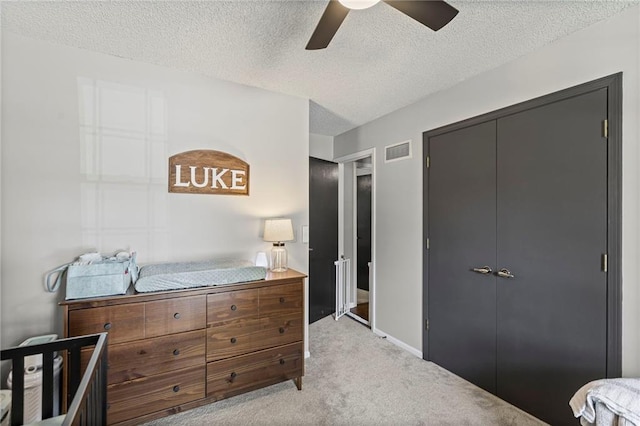 1413 SE 1st Ter, Lees Summit, MO 64063 - bedroom with a textured ceiling, light carpet, a closet, and ceiling fan