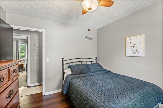1413 SE 1st Ter, Lees Summit, MO 64063 - bedroom featuring wood finished floors, a textured ceiling, and a ceiling fan