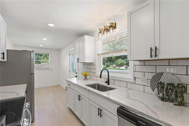 2 Overhill Dr, Paola, KS 66071 - kitchen with range with electric cooktop, dishwasher, light wood finished floors, recessed lighting, and white cabinetry