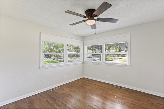 2 Overhill Dr, Paola, KS 66071 - empty room featuring plenty of natural light, wood finished floors, a textured ceiling, and ceiling fan