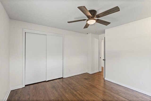 2 Overhill Dr, Paola, KS 66071 - unfurnished bedroom featuring wood finished floors, a closet, and a ceiling fan