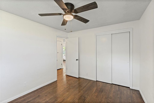2 Overhill Dr, Paola, KS 66071 - unfurnished bedroom with wood finished floors, a closet, and a ceiling fan