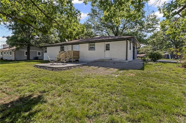 2 Overhill Dr, Paola, KS 66071 - back of house with a patio and a lawn