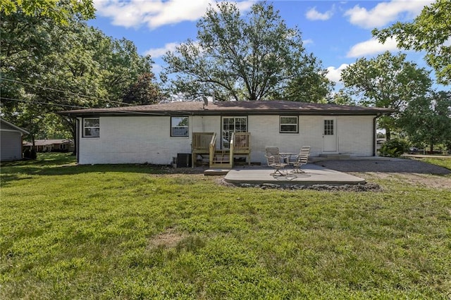 2 Overhill Dr, Paola, KS 66071 - back of property with concrete block siding, a yard, and a patio