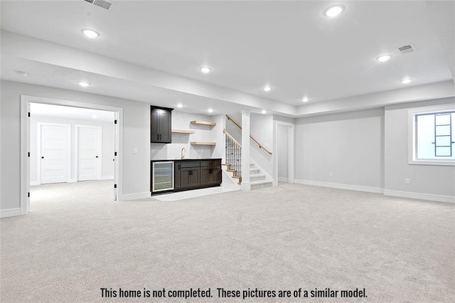 11275 S Gleason Rd, Olathe, KS 66061 - unfurnished living room featuring beverage cooler, light colored carpet, recessed lighting, wet bar, and stairway
