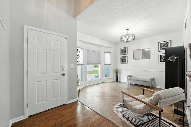 5136 NE Ash Grove Dr, Lees Summit, MO 64064 - foyer entrance featuring a chandelier and a textured ceiling