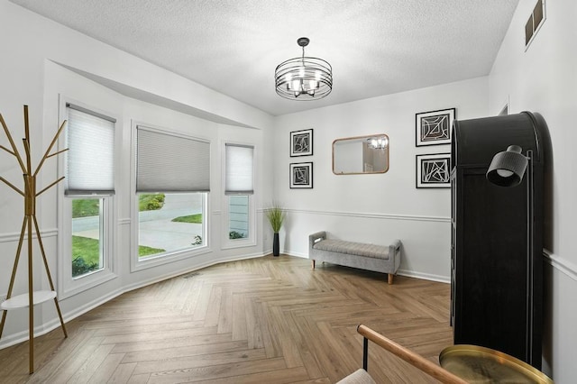 5136 NE Ash Grove Dr, Lees Summit, MO 64064 - sitting room featuring a chandelier and a textured ceiling