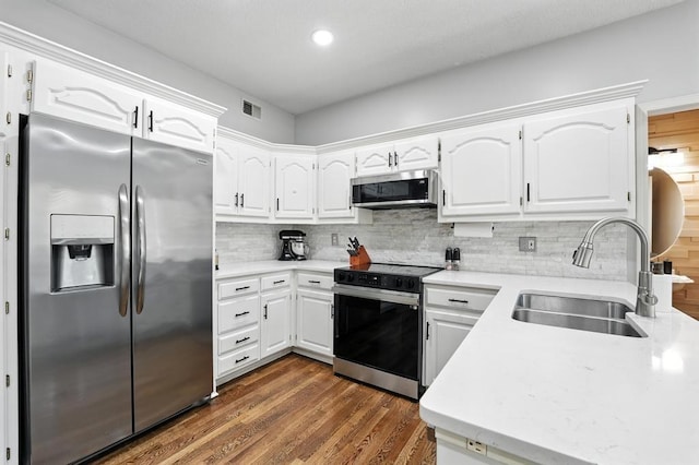 5136 NE Ash Grove Dr, Lees Summit, MO 64064 - kitchen featuring stainless steel appliances, backsplash, dark wood-style flooring, white cabinets, and recessed lighting