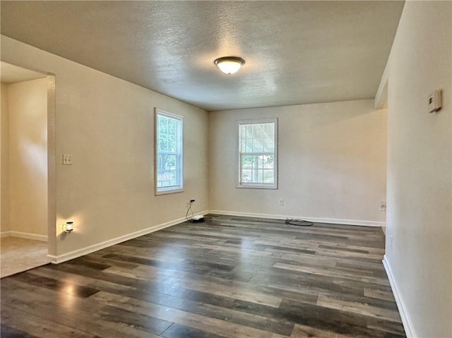 400 Webster St, Chillicothe, MO 64601 - spare room featuring dark wood-type flooring and a textured ceiling