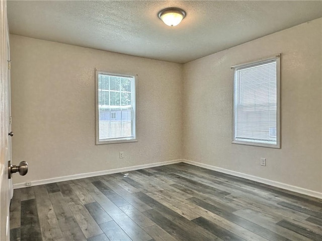 400 Webster St, Chillicothe, MO 64601 - spare room featuring dark wood-style flooring and a textured ceiling