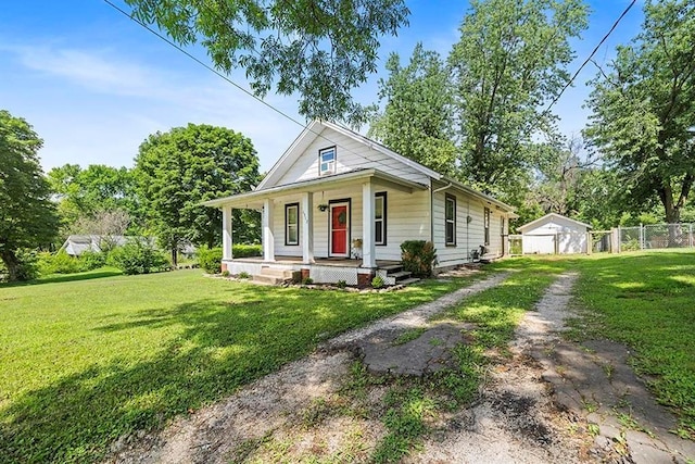 1312 N Main St, Nevada, MO 64772 - view of front facade with a porch, driveway, and a garage