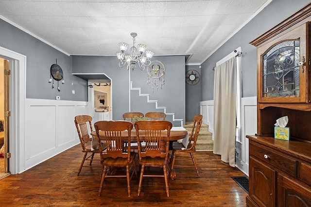1312 N Main St, Nevada, MO 64772 - dining space featuring crown molding, stairway, a decorative wall, a wainscoted wall, and dark wood finished floors