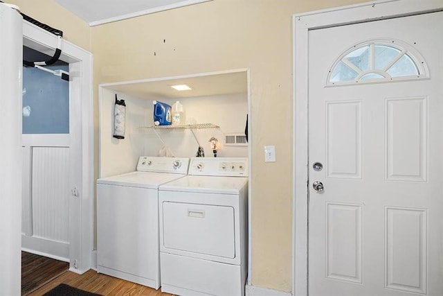 1312 N Main St, Nevada, MO 64772 - laundry area featuring washer and dryer and wood finished floors