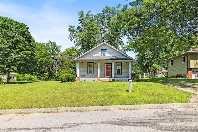 1312 N Main St, Nevada, MO 64772 - bungalow-style house with a porch