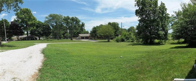 901 School Rd, Peculiar, MO 64078 - view of home's community featuring a lawn and view of wooded area