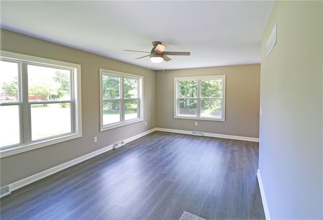 901 School Rd, Peculiar, MO 64078 - spare room with ceiling fan and dark wood-type flooring