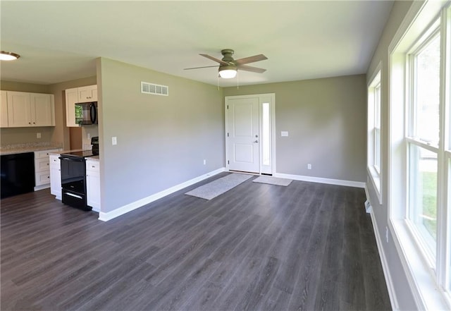 901 School Rd, Peculiar, MO 64078 - unfurnished living room featuring a ceiling fan and dark wood-style floors
