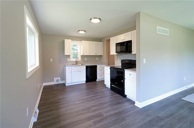 901 School Rd, Peculiar, MO 64078 - kitchen featuring black appliances, dark wood-type flooring, and white cabinetry