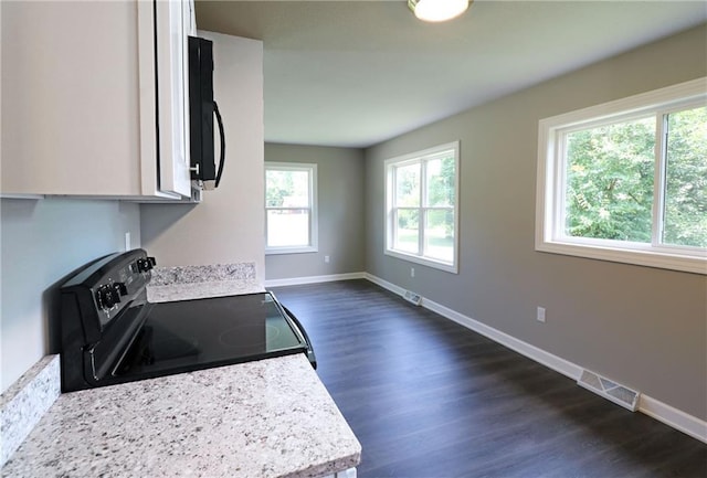 901 School Rd, Peculiar, MO 64078 - kitchen featuring range with electric stovetop, light countertops, and dark wood-style flooring