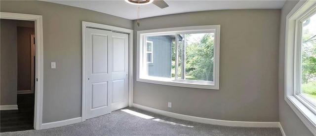 901 School Rd, Peculiar, MO 64078 - unfurnished bedroom featuring multiple windows, carpet, and a closet