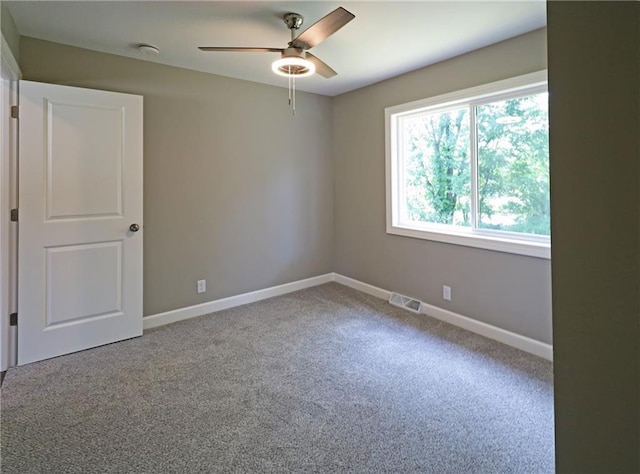 901 School Rd, Peculiar, MO 64078 - spare room featuring ceiling fan, carpet flooring, and a smoke detector