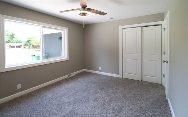901 School Rd, Peculiar, MO 64078 - unfurnished bedroom with carpet, a closet, and a ceiling fan