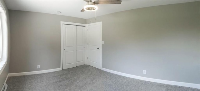 901 School Rd, Peculiar, MO 64078 - unfurnished bedroom featuring carpet, a closet, and a ceiling fan