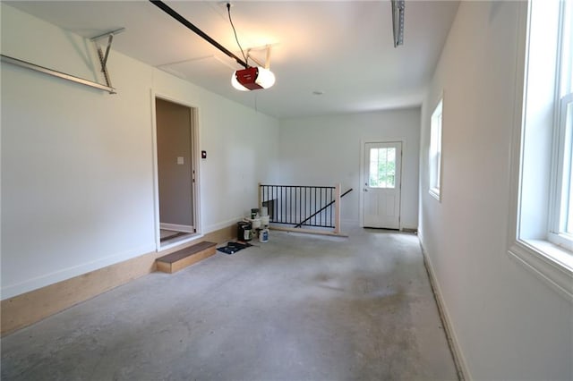 901 School Rd, Peculiar, MO 64078 - garage featuring a garage door opener and baseboards