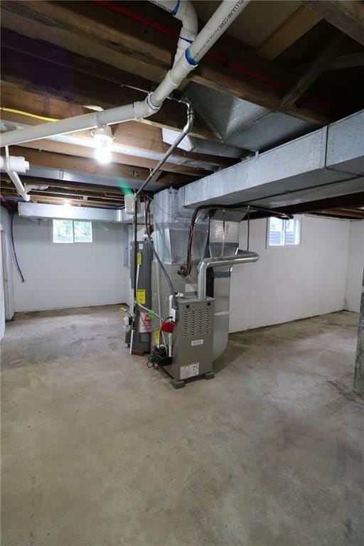 901 School Rd, Peculiar, MO 64078 - below grade area featuring gas water heater, heating unit, and healthy amount of natural light