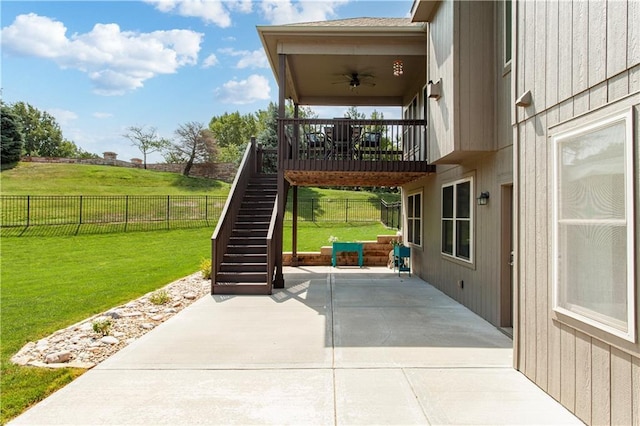 22908 E 41st Ter S, Blue Springs, MO 64015 - fenced backyard featuring a ceiling fan, a patio area, and stairs
