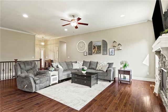 22908 E 41st Ter S, Blue Springs, MO 64015 - living area with ceiling fan, a fireplace, dark wood-style flooring, recessed lighting, and crown molding