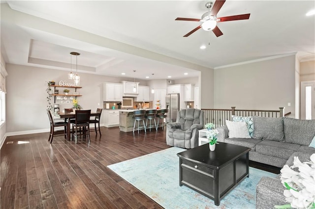 22908 E 41st Ter S, Blue Springs, MO 64015 - living room featuring a ceiling fan, dark wood-style flooring, crown molding, and recessed lighting