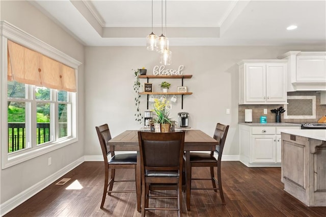 22908 E 41st Ter S, Blue Springs, MO 64015 - dining space with dark wood finished floors, a tray ceiling, crown molding, recessed lighting, and a chandelier