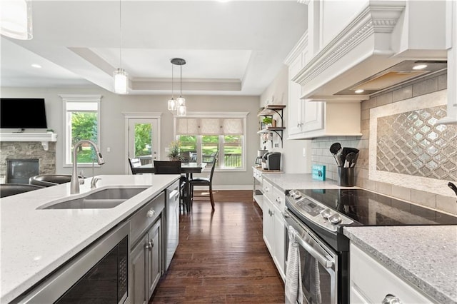 22908 E 41st Ter S, Blue Springs, MO 64015 - kitchen featuring appliances with stainless steel finishes, premium range hood, healthy amount of natural light, dark wood-style flooring, and recessed lighting