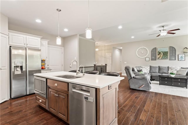 22908 E 41st Ter S, Blue Springs, MO 64015 - kitchen with appliances with stainless steel finishes, dark wood-style flooring, light countertops, an island with sink, and ceiling fan