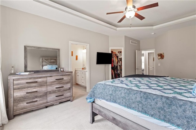 22908 E 41st Ter S, Blue Springs, MO 64015 - bedroom featuring light carpet, a walk in closet, connected bathroom, ceiling fan, and a raised ceiling